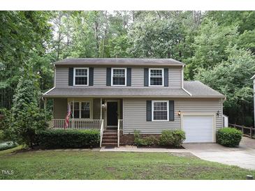 Charming two-story home with a well-manicured lawn and cozy front porch at 116 Trinity Woods Dr, Raleigh, NC 27607