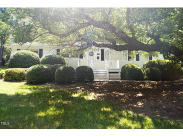 Charming home with a well-manicured lawn and mature landscaping, including a large shade tree at 1307 Sycamore Dr, Garner, NC 27529