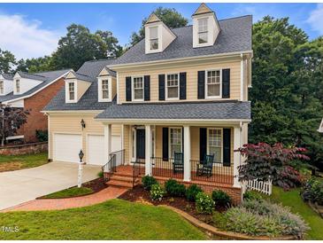 Charming two-story home featuring a welcoming front porch and well-manicured landscaping at 1412 Kings Lassiter Way, Raleigh, NC 27614