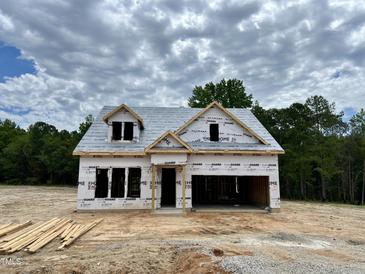 New home construction featuring a two-story design, open garage, and timbered lumber in a partly cloudy setting at 477 Beacon Hill Rd # 29, Lillington, NC 27546