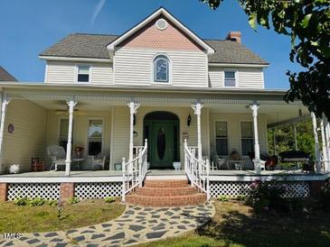 Charming two-story home with a welcoming front porch and well-maintained landscaping at 526 Bob Rainey Trl, Burlington, NC 27217