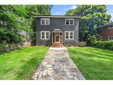 Charming two-story home with a stone walkway leading to the front door and well-manicured lawn at 924 W Trinity Ave, Durham, NC 27701