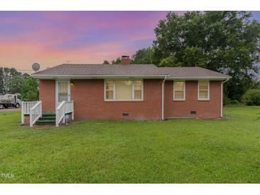 Cozy brick home featuring well-kept lawn and secure ADT protection at 1209 Bobbitt Dr, Garner, NC 27529
