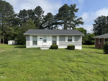 Charming single story home with manicured lawn and mature trees at 124 Kearney Ave, Oxford, NC 27565