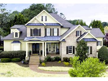 Charming two-story brick home with a manicured front yard and inviting covered front porch at 1512 Obrien Cir, Wake Forest, NC 27587