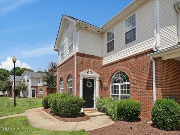 Charming townhome with a welcoming front entrance, well-maintained landscaping, and brick facade at 2021 Rivergate Rd # 102, Raleigh, NC 27614