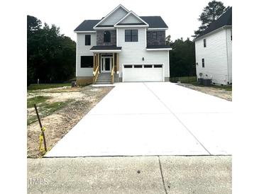 Two-story home features a wide driveway leading to an attached two-car garage at 2651 Bowden Dr, Creedmoor, NC 27522