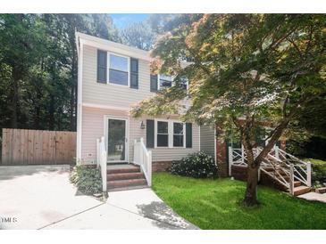 Charming two-story home boasts a well-manicured lawn and inviting front porch with green shutters at 404 Shannonford Ct, Wake Forest, NC 27587