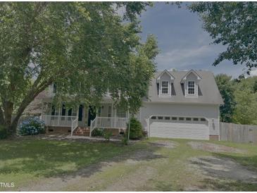 Charming two-story home with a welcoming front porch and attached two-car garage at 133 Rustic Ln, Smithfield, NC 27577