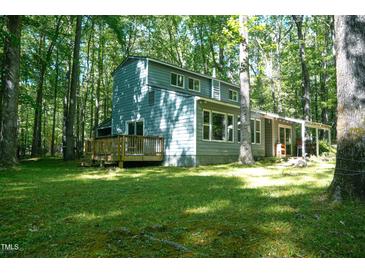 Quaint two-story home nestled among mature trees on a sunny lot at 1423 Alderman Cir, Raleigh, NC 27603
