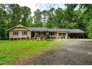 Charming ranch-style home featuring a welcoming front porch, carport, and lovely landscaped front yard at 224 Oakcrest Dr, Wake Forest, NC 27587