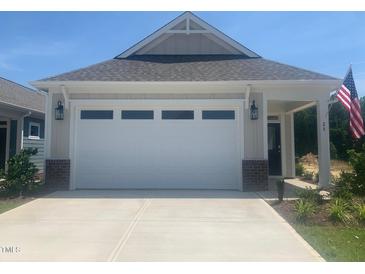 View of the home's garage and driveway at 28 Carteret Ct, Clayton, NC 27527