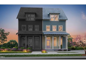 Charming two-story home featuring a covered porch and a combination of painted and unfinished wood siding at 2940 C Chapel Hill Road, Durham, NC 27707