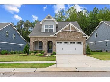 Charming brick home with a well-maintained lawn and a two-car garage, a perfect blend of style and functionality at 857 Whistable Ave, Wake Forest, NC 27587