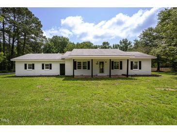 Charming single-story brick home with a welcoming front porch and a well-manicured lawn at 1067 Thompson Rd, Four Oaks, NC 27524
