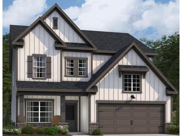 Charming two-story home features board and batten siding, gray trim, and an attached two-car garage at 1413 Malcus Ct # 61, Fuquay Varina, NC 27526