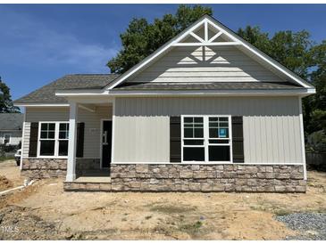 Charming single-Gathering home featuring stone accents, dark shutters, and an inviting covered entrance at 202 S Pearl St, Princeton, NC 27569