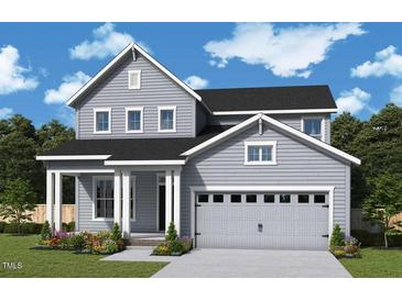 Charming two-story home with gray siding, black roof, an attached two car garage and a welcoming front porch at 25 Cozy Hvn, Fuquay Varina, NC 27526
