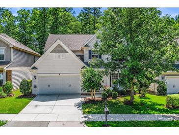 Charming two-story home with a well-maintained lawn and a two car garage at 3661 Manifest Pl, Cary, NC 27519