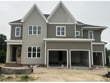 Two story home with a three car garage and large windows at 1025 Azalea Garden Cir, Raleigh, NC 27603