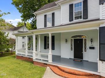 Charming front porch with white columns and black shutters enhances this home's curb appeal at 112 Rectory St, Oxford, NC 27565