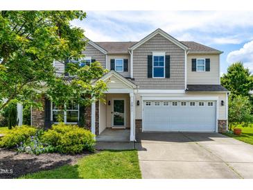 Charming two-story home with a two-car garage, stone accents, and inviting curb appeal at 2011 Unbridled Dr, Knightdale, NC 27545
