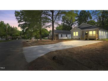 Charming home featuring a long driveway and well-maintained landscaping at 2305 Pinecroft Dv, Burlington, NC 27217