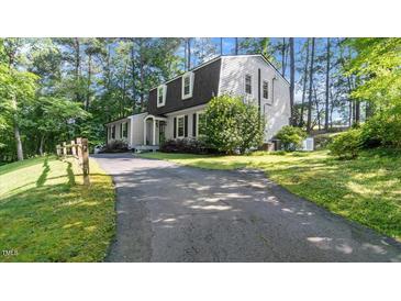 Charming home exterior features a long driveway and traditional architectural details surrounded by mature trees at 3070 Cameron Dr, Henderson, NC 27536