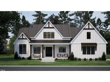 Charming craftsman-style home showcasing a symmetrical façade, covered porch, and manicured lawn at 50 Heritage Trail, Zebulon, NC 27597