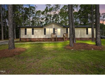Charming home with a manicured lawn and surrounded by mature trees at 101 Hunter Fld, Sanford, NC 27332