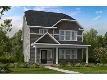 Charming two-story home with a covered front porch and well-maintained landscaping at 1053 Hardin Hill Ln, Knightdale, NC 27545