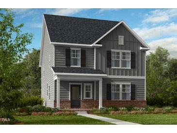 Charming two-story home with gray siding, black shutters, and a cozy front porch at 1216 Hardin Hill Ln, Knightdale, NC 27545