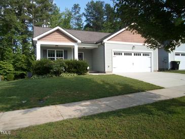 Charming single-story home featuring a well-maintained lawn and an attached two-car garage at 126 Kipling Dr, Oxford, NC 27565