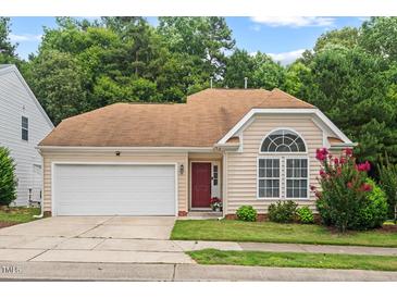 Charming one-story home with a two-car garage, red door, and inviting curb appeal at 1406 Pebble Creek Xing, Durham, NC 27713