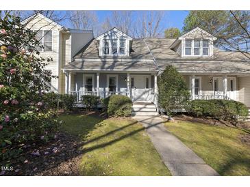 Charming home featuring a welcoming front porch, manicured lawn, and inviting curb appeal at 1634 Claiborne Ct, Raleigh, NC 27606