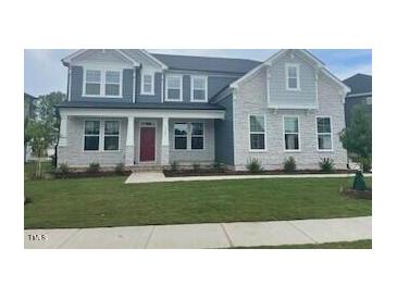 Beautiful two-story home with a well-manicured lawn and a welcoming front entrance at 3521 Bailey Lake Dr, Fuquay Varina, NC 27526