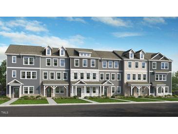 New townhome exteriors showcasing modern architectural designs, complemented by lush landscaping, and attractive curb appeal at 412 Rowe Way, Knightdale, NC 27545