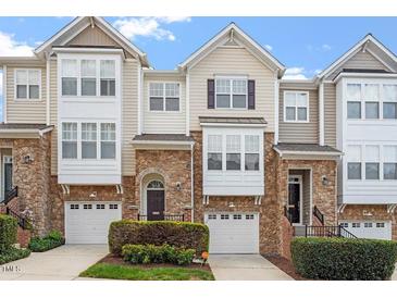Charming townhouse exterior showcasing stone accents, private garages, and neat landscaping at 5003 Celtic Ct, Raleigh, NC 27612