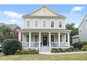Charming two-story home with a welcoming front porch and well-maintained landscaping at 113 Market Cross Ct, Holly Springs, NC 27540