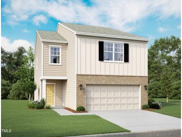 Charming two-story home featuring a brick-accented garage, board and batten siding, and a well-manicured lawn at 1217 Solace Way, Rolesville, NC 27571
