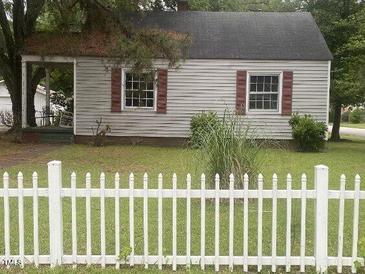 Charming home featuring red shutters and a quaint white picket fence at 1256 Planters St, Rocky Mount, NC 27801