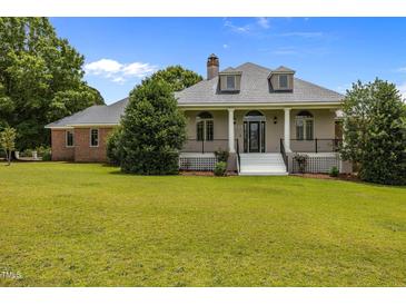 Charming home featuring a well-manicured front yard, classic architectural design and inviting entryway at 1672 Wheeler Dr, Angier, NC 27501