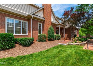 Charming brick home with well-manicured lawn, lush landscaping, and inviting curb appeal at 1831 Middlebrook Dr, Raleigh, NC 27615