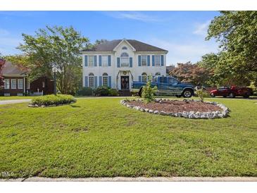 Charming two-story house with blue shutters, manicured lawn, and decorative landscaping at 3013 Brassfield Dr, Rocky Mount, NC 27803