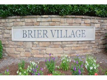 Stone monument sign in a flower bed displaying the community's name, Brier Village at 321 Westgrove Ct, Durham, NC 27703