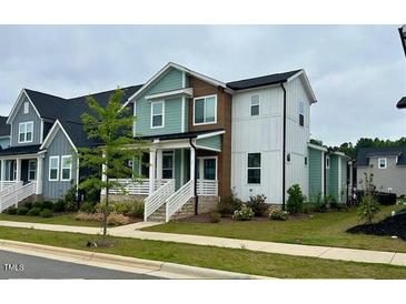 Charming two-story home with a combination of blue, brown, and white siding at 34 Millennium Dr, Pittsboro, NC 27312