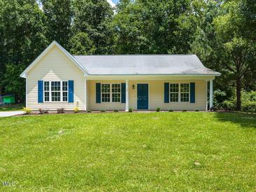 Charming single-story home with blue shutters and a well-manicured lawn at 381 Gray Ghost Ln, Benson, NC 27504