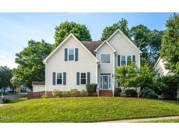 Charming two-story home with blue shutters and manicured lawn at 8701 Erinsbrook Dr, Raleigh, NC 27617