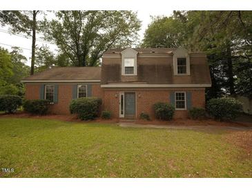 Charming brick home with manicured lawn, mature trees, and inviting curb appeal at 1513 Western Ave, Rocky Mount, NC 27804