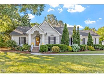 Charming home featuring manicured landscaping, a well-maintained lawn and elegant front entry with classic architectural details at 1819 Umstead Rd, Durham, NC 27712
